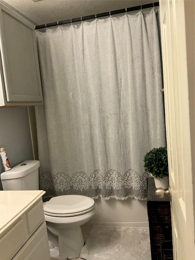 full bathroom with vanity, shower / bath combination with curtain, a textured ceiling, and toilet