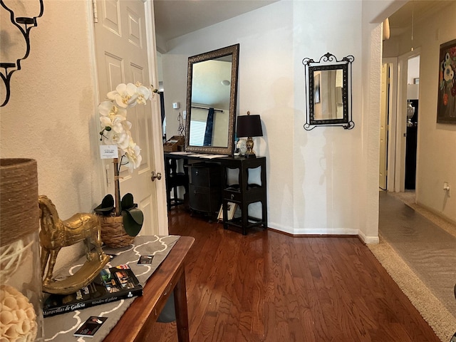 hallway with dark hardwood / wood-style floors