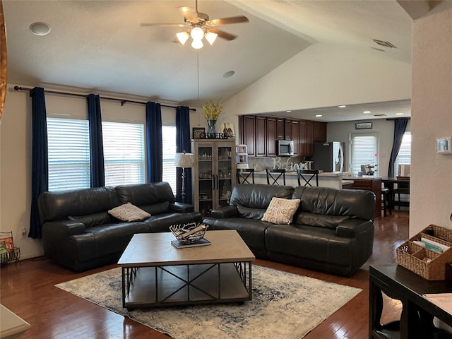 living room with dark hardwood / wood-style flooring, ceiling fan, and lofted ceiling