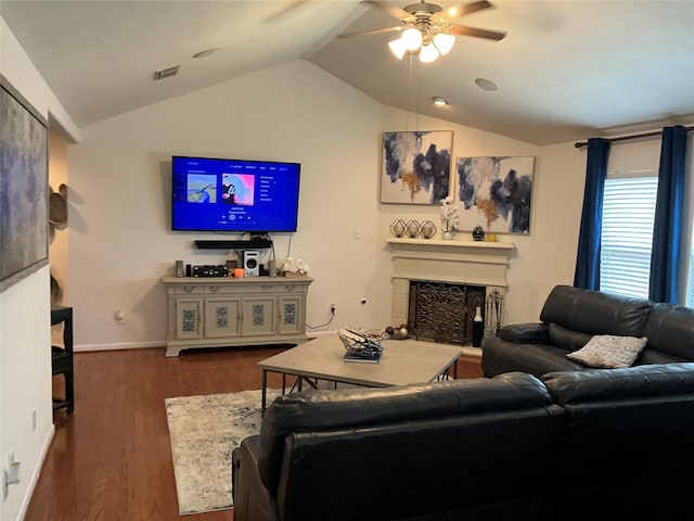 living room featuring ceiling fan, dark hardwood / wood-style floors, and vaulted ceiling