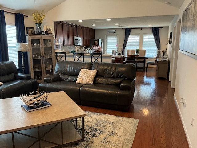 living room featuring dark hardwood / wood-style floors and lofted ceiling