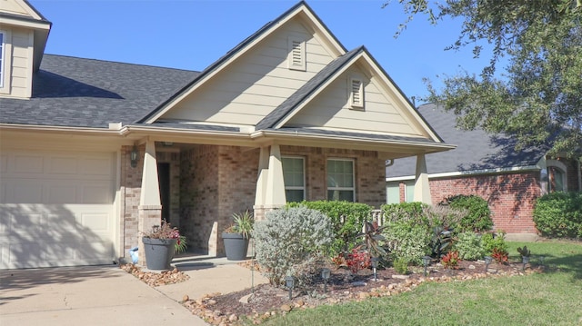 view of front of home featuring a porch and a garage