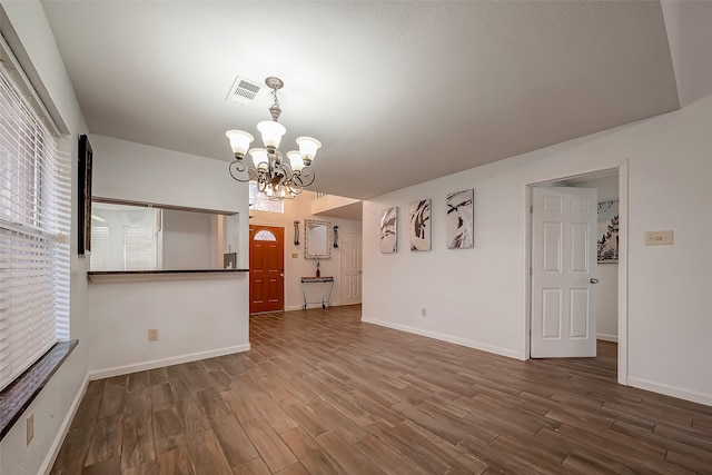 interior space featuring a notable chandelier and wood-type flooring