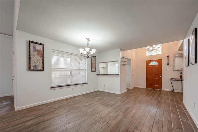 5110 Prairie Creek Dr, Houston, TX 77084 - foyer entrance featuring a chandelier, dark wood-type flooring, and baseboards