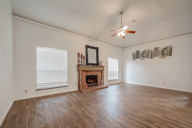 unfurnished living room with ornamental molding, wood-type flooring, a fireplace, and ceiling fan