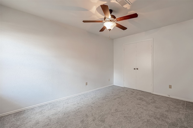 unfurnished bedroom with a closet, carpet, and ceiling fan