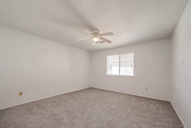 carpeted empty room featuring a textured ceiling and ceiling fan