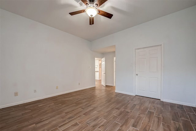 empty room with dark wood-type flooring and ceiling fan