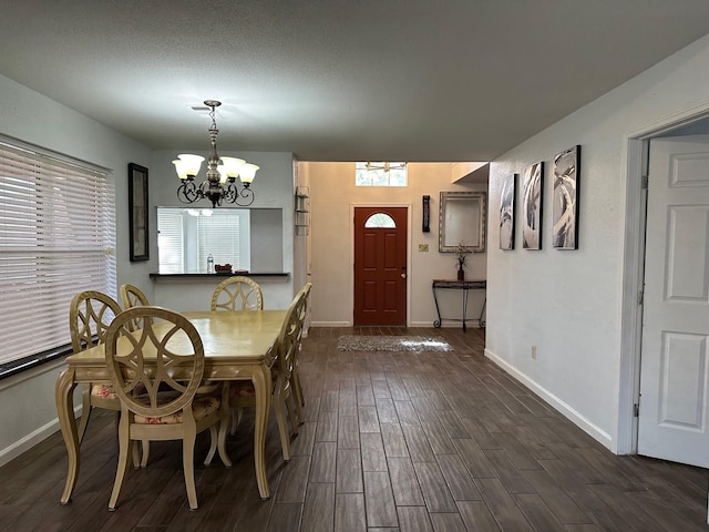 5110 Prairie Creek Dr, Houston, TX 77084 - dining area with a chandelier, dark wood finished floors, and baseboards