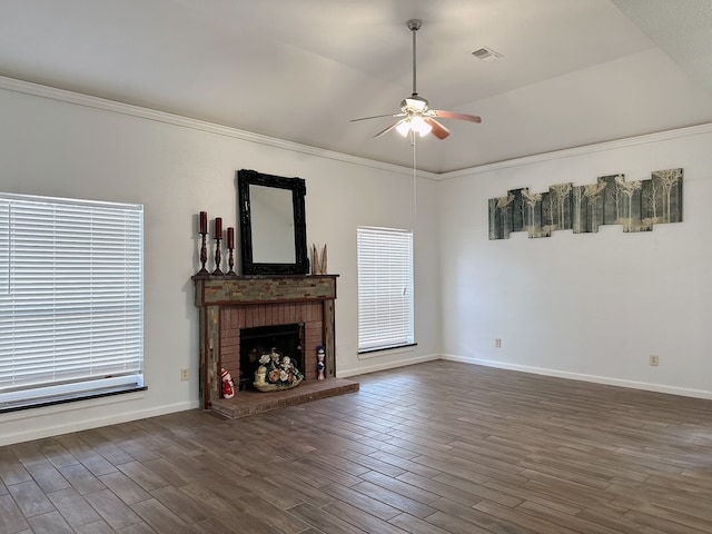 unfurnished living room featuring ceiling fan, ornamental molding, dark hardwood / wood-style flooring, and a brick fireplace