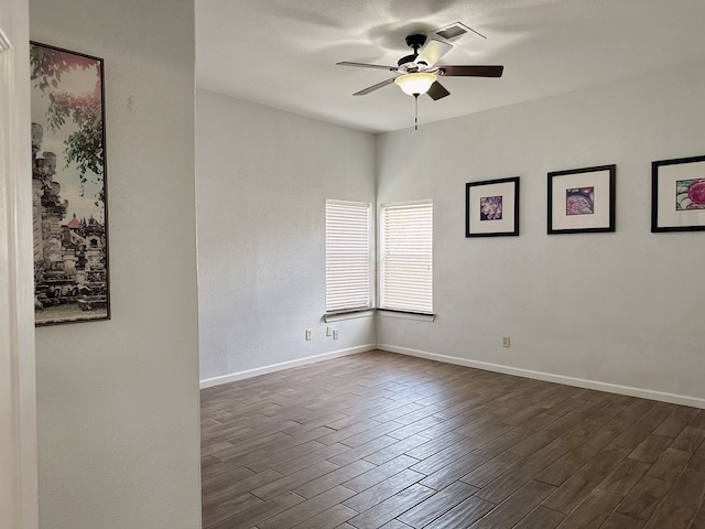 spare room with ceiling fan and dark hardwood / wood-style flooring