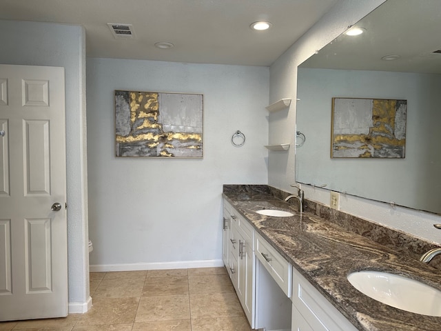 bathroom with vanity, toilet, and tile patterned flooring