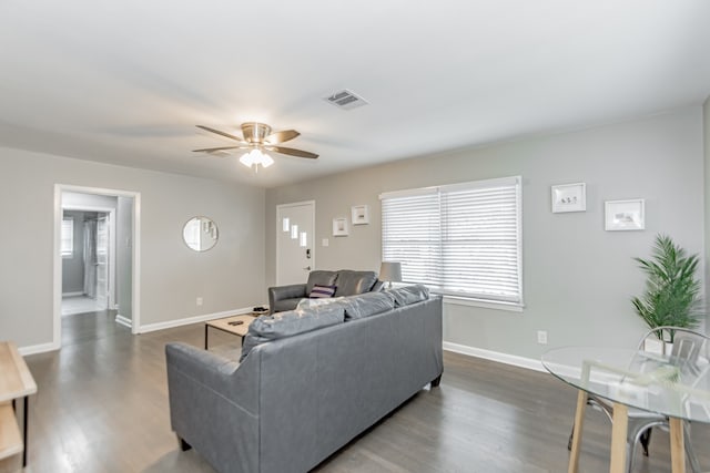 living room with ceiling fan and dark hardwood / wood-style floors