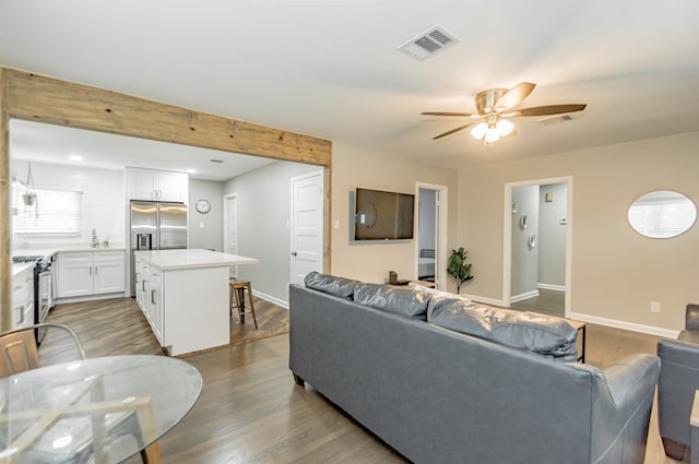 living room featuring ceiling fan, hardwood / wood-style flooring, and sink