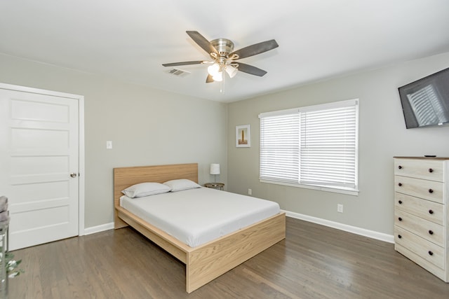 bedroom featuring ceiling fan and dark wood-type flooring