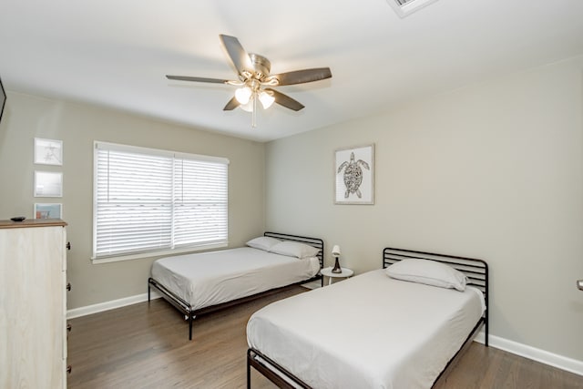 bedroom with dark wood-type flooring and ceiling fan