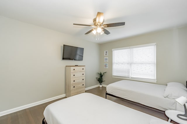 bedroom with ceiling fan and dark hardwood / wood-style floors