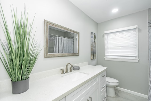 bathroom featuring tile patterned floors, vanity, and toilet