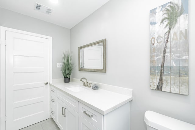 bathroom featuring tile patterned floors, vanity, and toilet