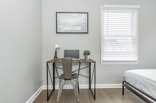 bedroom with hardwood / wood-style flooring