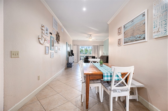 tiled dining room featuring ornamental molding and ceiling fan