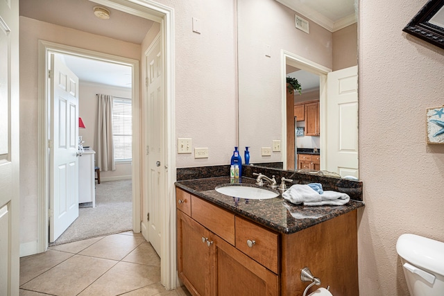 bathroom featuring ornamental molding, vanity, tile patterned flooring, and toilet