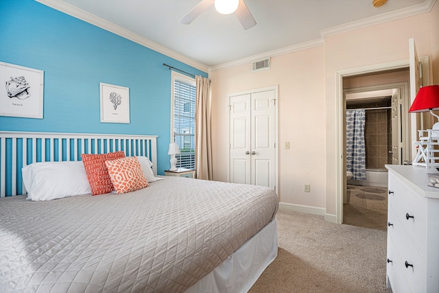 bedroom with ornamental molding, ceiling fan, light colored carpet, and a closet