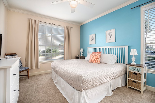 carpeted bedroom with ornamental molding and ceiling fan