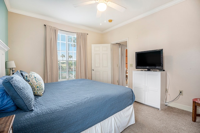 carpeted bedroom with ornamental molding and ceiling fan