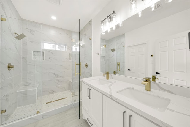 bathroom featuring walk in shower and vanity