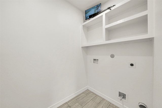 washroom featuring hookup for a washing machine, hookup for a gas dryer, hookup for an electric dryer, and light hardwood / wood-style flooring