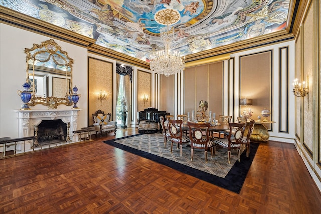 dining room with a fireplace, parquet flooring, a high ceiling, ornamental molding, and a chandelier