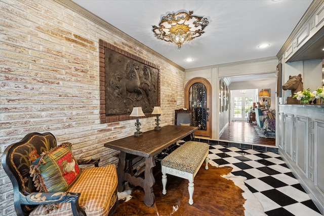 interior space featuring ornamental molding, brick wall, and french doors