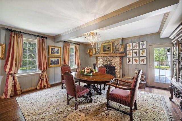 dining room with hardwood / wood-style flooring, plenty of natural light, and a fireplace