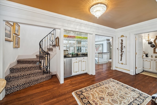 entrance foyer with crown molding and dark hardwood / wood-style flooring