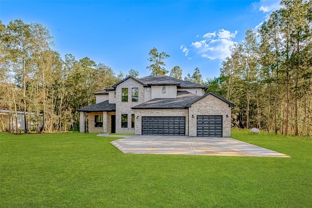 view of front of home with a garage and a front lawn