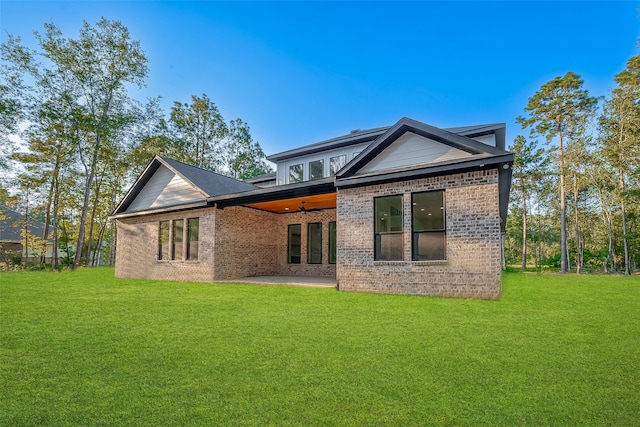 back of house with a yard and a patio area