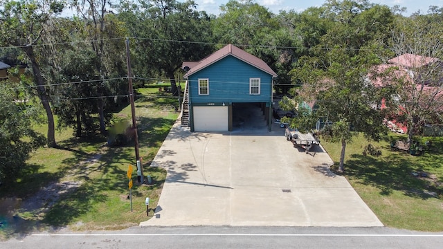 view of front of property featuring a garage and a carport