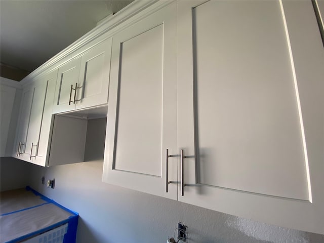 laundry room featuring cabinets