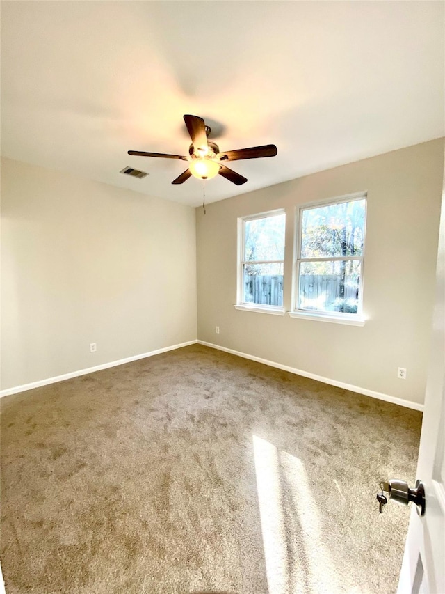 spare room with carpet and ceiling fan