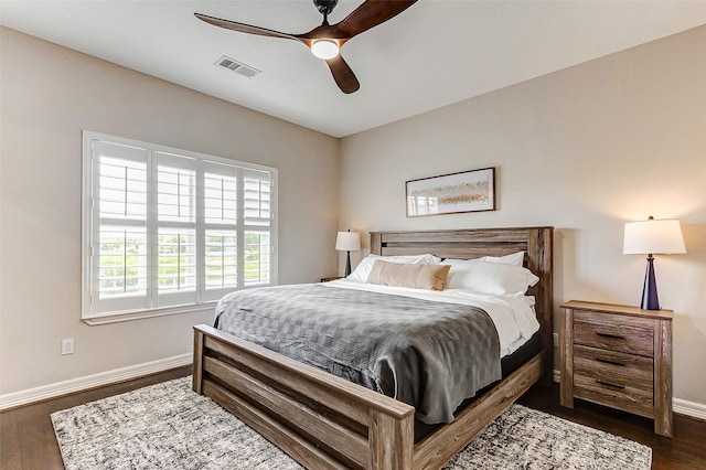 bedroom with dark wood-type flooring and ceiling fan