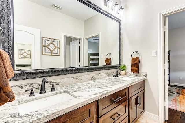 bathroom with vanity and hardwood / wood-style floors