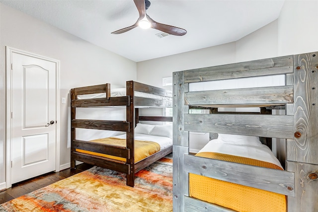 bedroom with ceiling fan and dark hardwood / wood-style floors