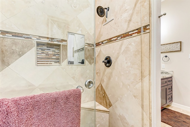 bathroom with a tile shower, hardwood / wood-style floors, and vanity