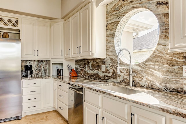 kitchen with appliances with stainless steel finishes, decorative backsplash, light stone countertops, and sink