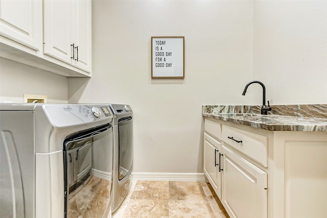 laundry area featuring separate washer and dryer and cabinets