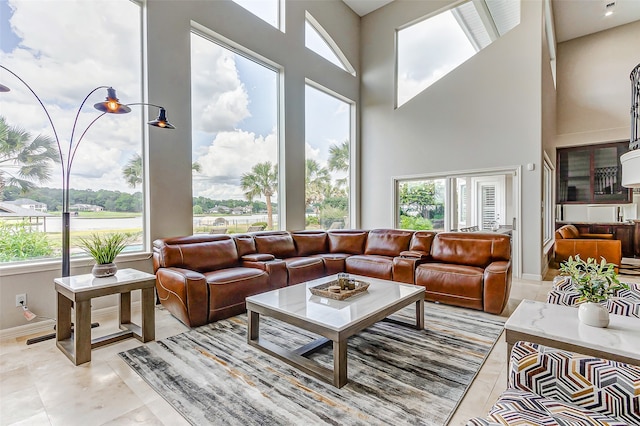 tiled living room featuring a towering ceiling