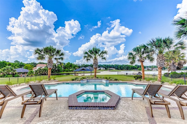 view of swimming pool with an in ground hot tub, a patio area, and a yard