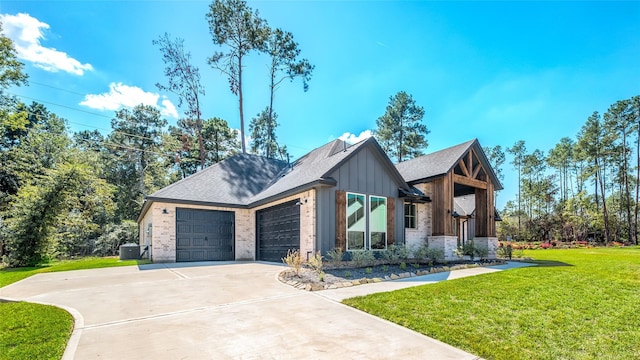 view of front of home with a garage, central air condition unit, and a front yard