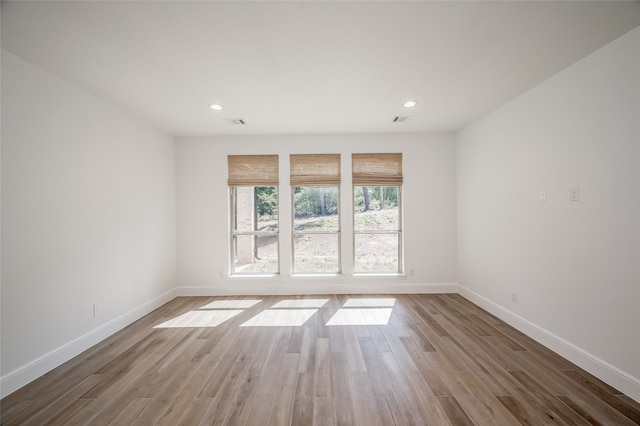 spare room with wood-type flooring